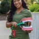 Student dentist, Taylor Jackson, holding large model teeth and a toothbrush